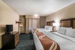a hotel room with two beds and a flat screen tv at Elevate Hotel at Sierra Blanca Ruidoso, Ascend Hotel Collection in Ruidoso