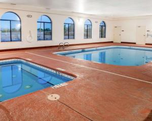 a large swimming pool in a building with windows at Comfort Inn & Suites in Socorro