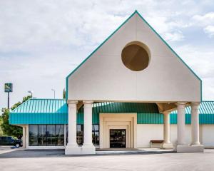 a large white building with a blue roof at Quality Inn Deming in Deming