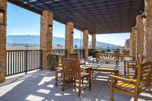 a patio with tables and chairs on a balcony at The Hotel at Sunland Park Casino El Paso, Ascend Hotel Collection in El Paso