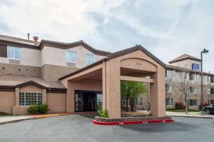 a building with a parking lot in front of it at Sleep Inn Airport in Albuquerque