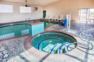 a pool in a hotel room with a swimming pool at Comfort Inn & Suites Near Fallon Naval Air Station in Fallon