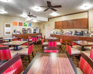 a restaurant with tables and chairs and a kitchen at Comfort Inn Elko in Elko