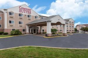 a hotel with a parking lot in front of it at Comfort Suites Rochester Henrietta University Area in Henrietta