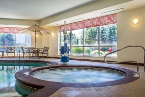 a jacuzzi tub in a hotel room with a pool at Sleep Inn in Amherst