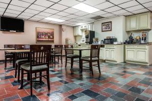 a kitchen with a table and chairs in a room at Quality Inn & Suites Binghamton Vestal in Binghamton
