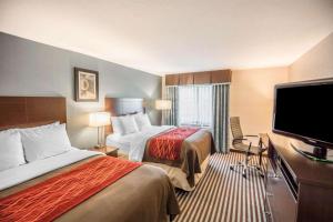 a hotel room with two beds and a flat screen tv at Quality Inn in Corning