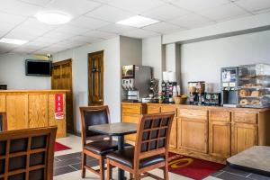 a restaurant with a table and chairs and a counter at Econo Lodge in Brockport