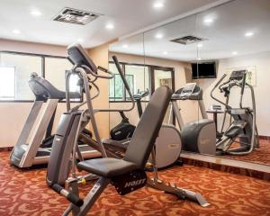 a gym with several tread machines in a room at Quality Inn Buffalo Airport in Cheektowaga