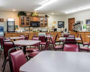 a restaurant with tables and chairs and a kitchen at Quality Inn Lake George in Lake George