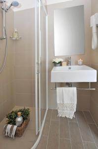 a white bathroom with a sink and a shower at Hotel Gradara in Bellaria-Igea Marina +26 photos