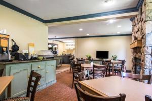 un restaurante con mesas y sillas y una cocina en Quality Inn University Area, en Cortland
