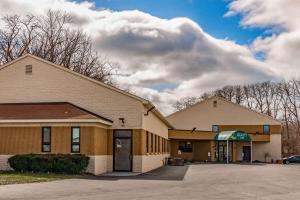 a building with a parking lot in front of it at Quality Inn Schenectady - Albany in Schenectady