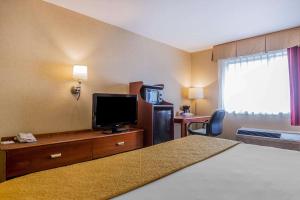 a hotel room with a bed and a flat screen tv at Quality Inn Hyde Park - Poughkeepsie North in Hyde Park