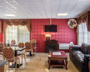 a living room with a couch and a table and chairs at Rodeway Inn Huntington Station - Melville in Huntington