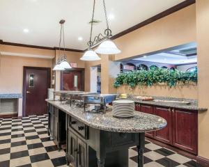 a large kitchen with a counter with dishes on it at The Marx Hotel - Downtown - University Area in Oneonta