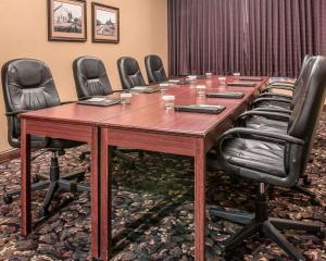 a conference room with a long wooden table and chairs at The Marx Hotel - Downtown - University Area in Oneonta