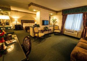 a hotel room with a bed and a living room at Garden Place Hotel in Buffalo