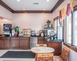 a kitchen with a table and a counter top at Amherst Inn & Suites in Amherst