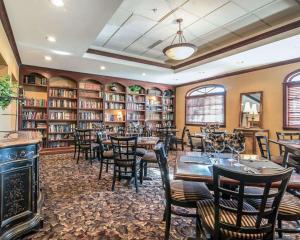 a dining room with tables and chairs in a library at The Marx Hotel - Downtown - University Area in Oneonta