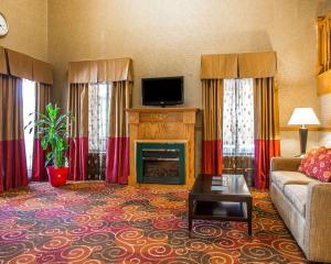 a living room with a couch and a fireplace at Quality Inn Greenville North in Greenville