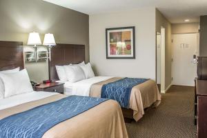 a hotel room with two beds in a room at Comfort Inn Sandusky in Sandusky