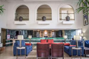 a lobby with blue couches and red chairs at Comfort Inn Sandusky in Sandusky