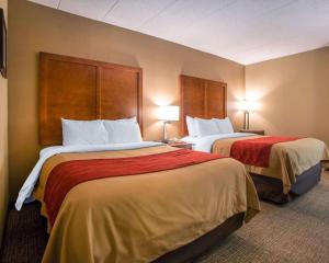 a hotel room with two beds and two lamps at Comfort Inn Dayton - Huber Heights in Huber Heights