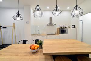 a kitchen with a wooden table with a bowl of fruit at Fishnjak Apartments - Central Zagreb in Zagreb +33 photos
