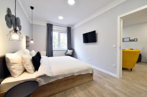 a bedroom with a large bed and a window at Fishnjak Apartments - Central Zagreb in Zagreb