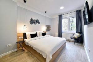 a bedroom with a large bed and a window at Fishnjak Apartments - Central Zagreb in Zagreb