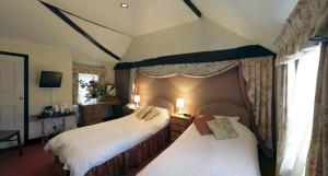 a hotel room with two beds and a window at Bath Place Hotel in Oxford