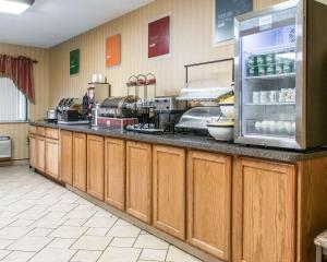 a kitchen with a counter with a refrigerator at Comfort Inn Maumee - Perrysburg Area in Maumee