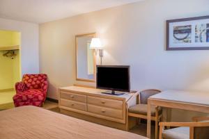 a hotel room with a bed, television and a desk at Quality Inn Port Clinton in Port Clinton