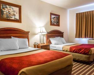 a hotel room with two beds and a window at Economy Inn & Suites in Warren