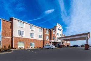 a large brick building with a car parked in a parking lot at Comfort Inn & Suites Dayton North in Dayton