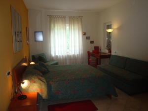 a bedroom with a bed and a couch and a desk at Apartments Mogorović in Mošćenička Draga