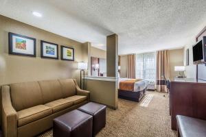 a hotel room with a couch and a bed at Comfort Inn & Suites Dayton North in Dayton