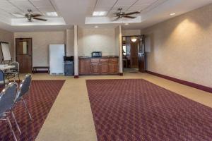 a large empty room with chairs and a refrigerator at Quality Inn & Suites Guymon in Guymon