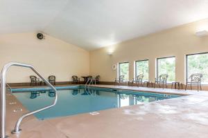 a large swimming pool with chairs in a building at Quality Inn I-75 West Chester-North Cincinnati in West Chester
