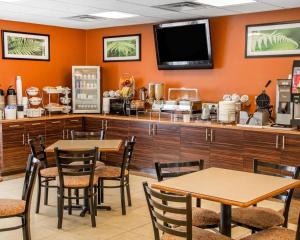 a restaurant with tables and a counter with a tv at Sleep Inn & Suites Oklahoma City Northwest in Oklahoma City