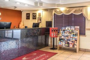 a bar in a restaurant with a counter with magazines at Econo Lodge Inn & Suites in Clinton