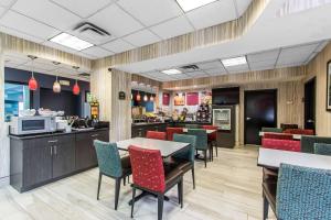 a restaurant with chairs and a table and a counter at Comfort Suites Fairgrounds West in Oklahoma City