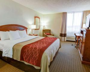 a hotel room with a large bed and a chair at Spark By Hilton Muskogee in Muskogee +29 photos