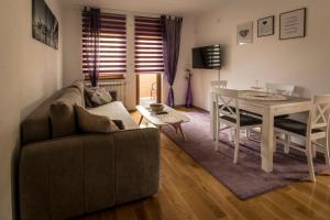 a living room with a couch and a table at Apartmani F&A in Zlatibor