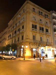 a large building on a city street at night at Petite Maison TA in Taranto