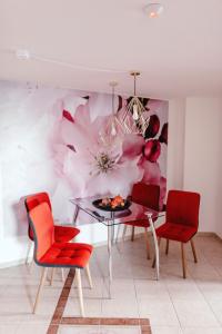 a dining room with a flower mural on the wall at Zelný trh 42 in Brno