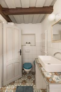 a bathroom with a sink and a toilet at Lovely Cottage Home in Velence