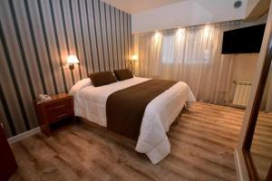מיטה או מיטות בחדר ב-Gran Hotel Skorpios