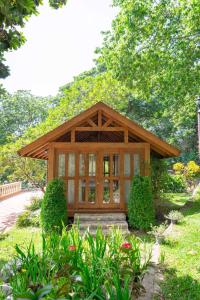 a small building with a porch in a garden at Hotel Gran Jimenoa in Jarabacoa +54 photos